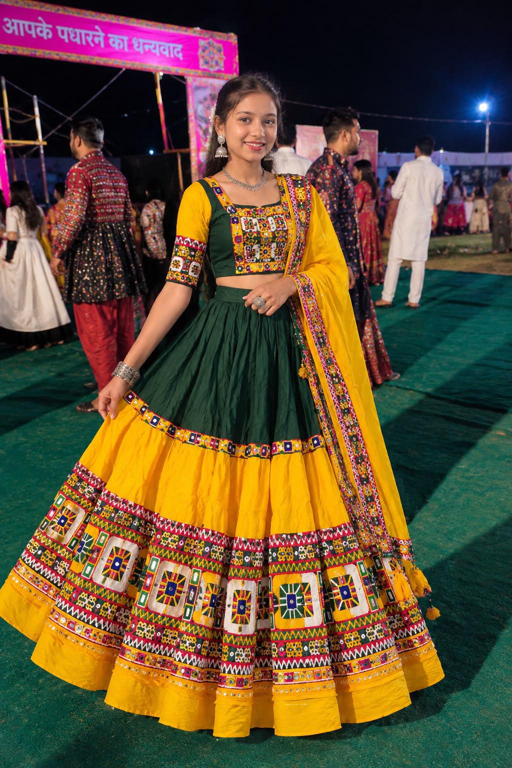 Woman in a green blouse and yellow chaniya with mirror-square panels